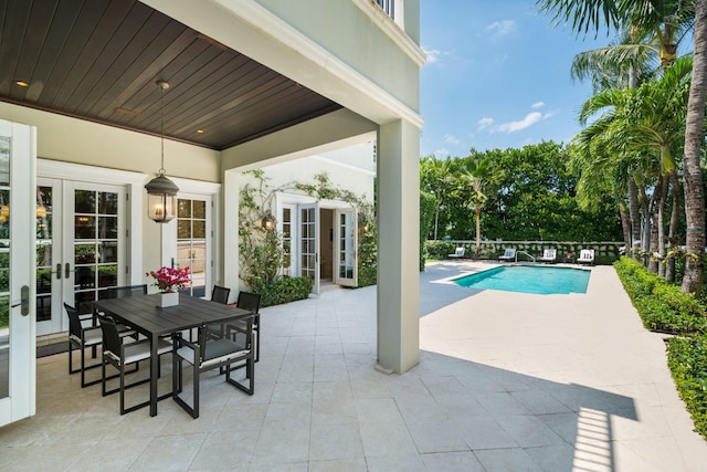 view of pool with french doors and a patio area