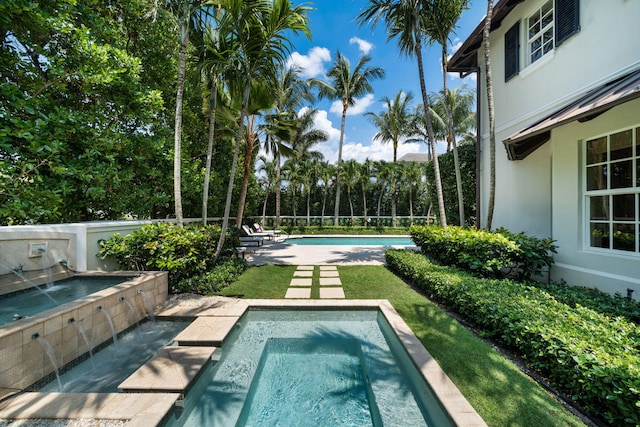 view of pool featuring an in ground hot tub