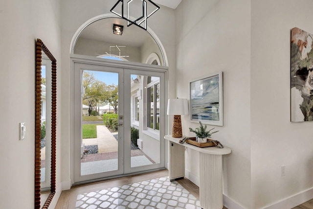 entryway featuring light hardwood / wood-style floors and french doors