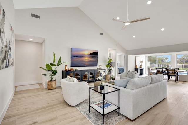 living room featuring ceiling fan and high vaulted ceiling