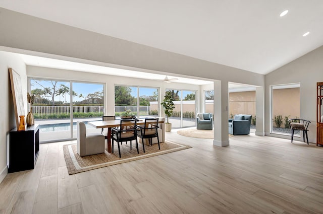 dining room featuring lofted ceiling and light hardwood / wood-style flooring