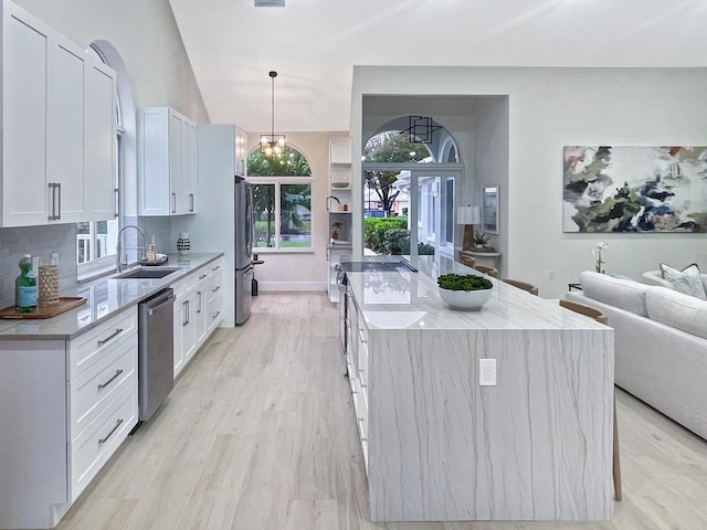 kitchen with white cabinets, stainless steel appliances, and pendant lighting