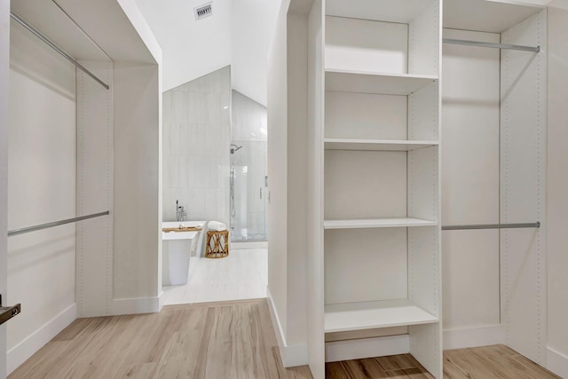 walk in closet featuring light hardwood / wood-style floors