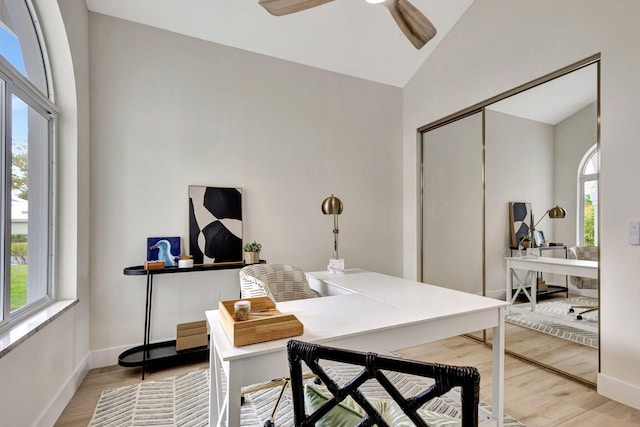 office featuring lofted ceiling, ceiling fan, and light hardwood / wood-style flooring