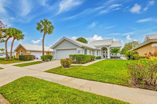 view of front facade with a garage and a front lawn