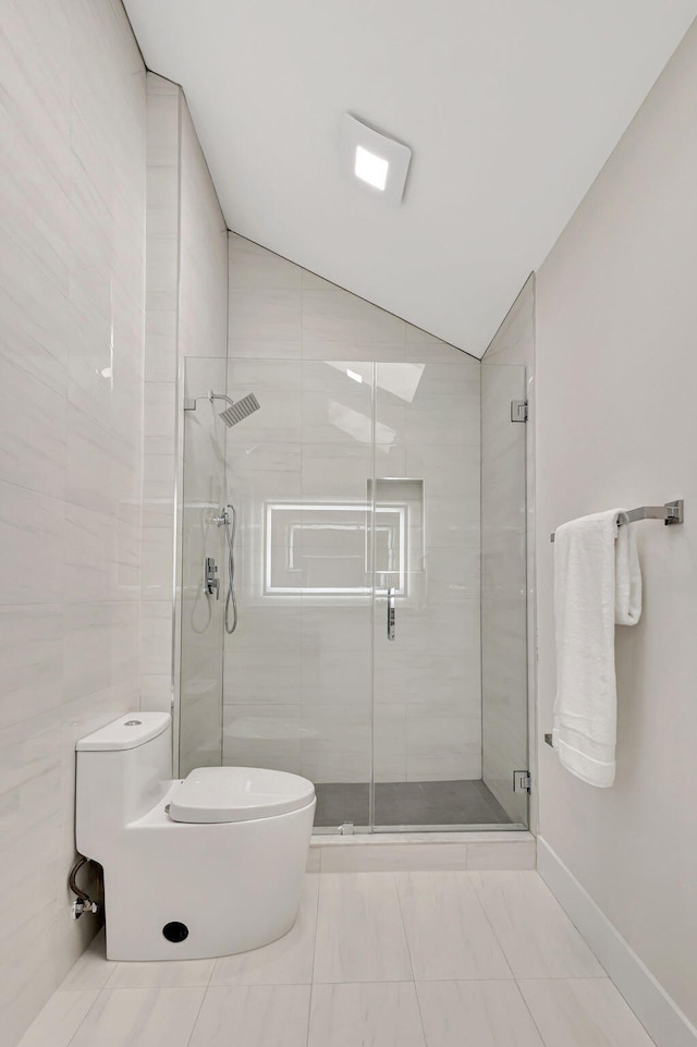 bathroom featuring an enclosed shower, lofted ceiling, and toilet