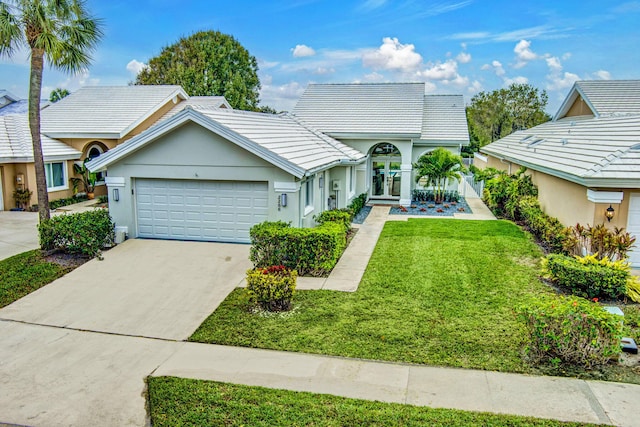 ranch-style home with a garage and a front yard