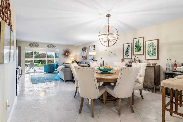 tiled dining room featuring an inviting chandelier