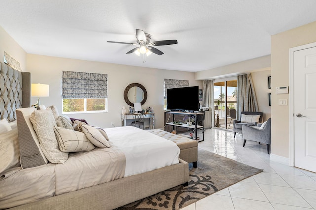 tiled bedroom featuring a textured ceiling and ceiling fan