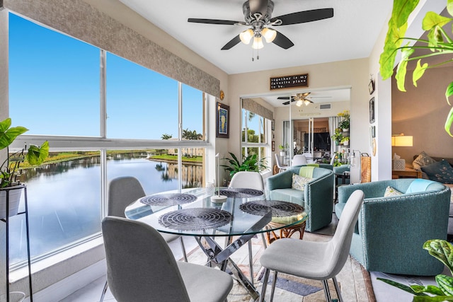 sunroom with a healthy amount of sunlight and ceiling fan