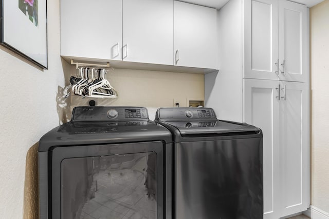 laundry area featuring cabinets and washer and clothes dryer