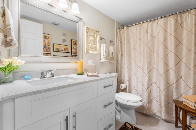 bathroom with vanity, toilet, curtained shower, and tile patterned flooring