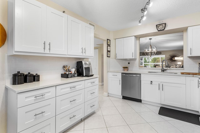 kitchen featuring sink, white cabinetry, hanging light fixtures, a textured ceiling, and stainless steel dishwasher