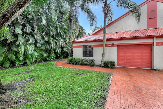 exterior space with a front yard and a garage