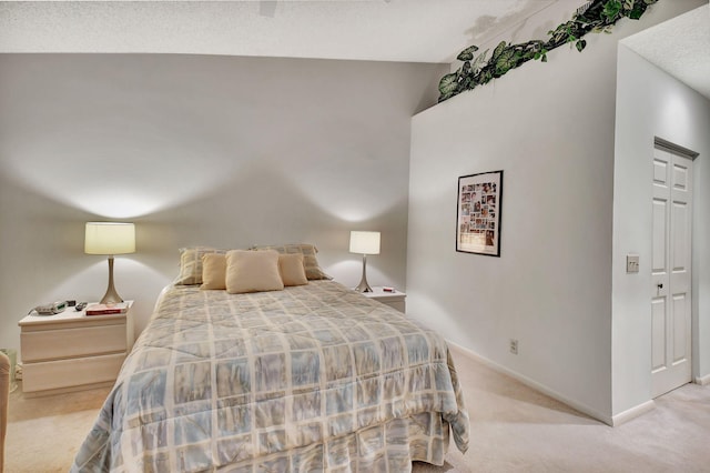 carpeted bedroom with vaulted ceiling