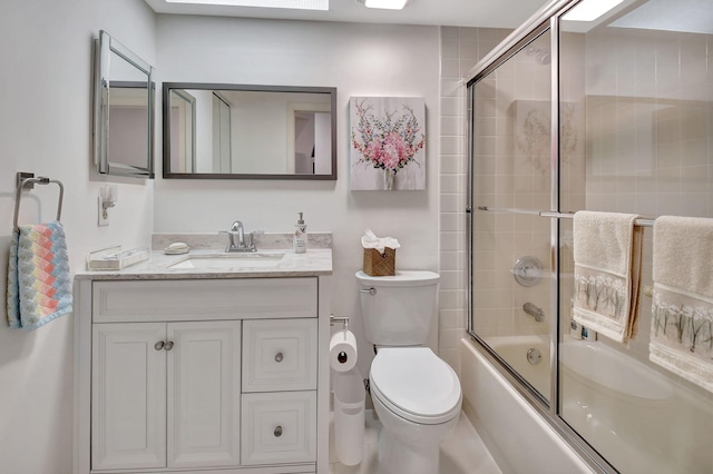 full bathroom with vanity, toilet, and bath / shower combo with glass door