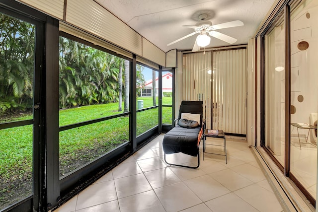 sunroom with a healthy amount of sunlight and ceiling fan