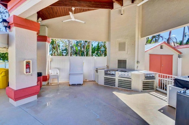 view of patio / terrace featuring a storage shed and ceiling fan