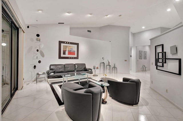 living room featuring vaulted ceiling and light tile patterned flooring