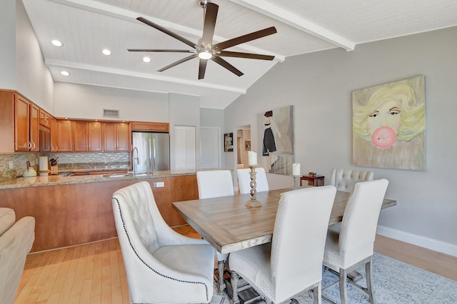 dining area with ceiling fan, light hardwood / wood-style flooring, high vaulted ceiling, and beamed ceiling