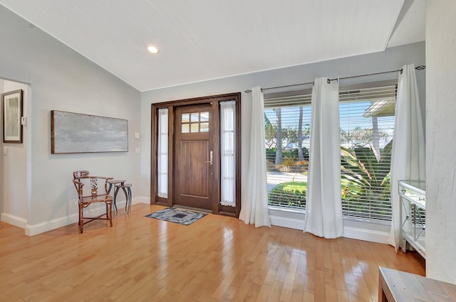 entrance foyer featuring vaulted ceiling and light wood-type flooring