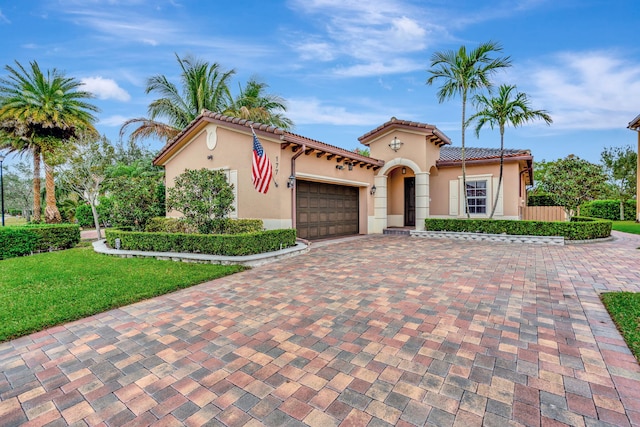 mediterranean / spanish-style home with a garage