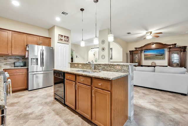 kitchen with stainless steel fridge with ice dispenser, dishwasher, a kitchen island with sink, sink, and pendant lighting