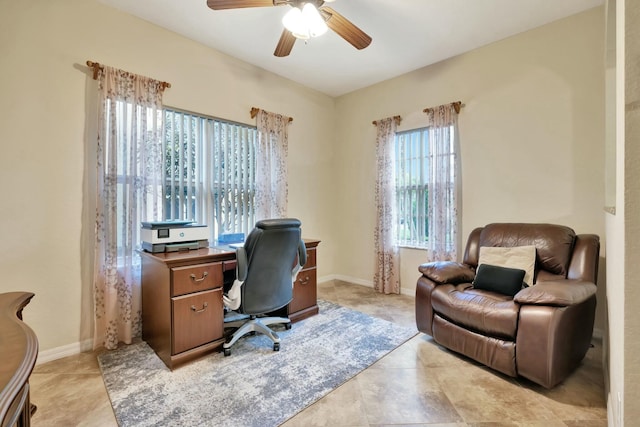 office space with a healthy amount of sunlight, light tile patterned floors, and ceiling fan