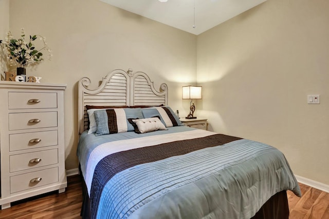 bedroom with dark hardwood / wood-style flooring