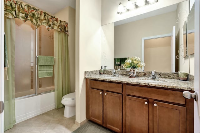 full bathroom with tile patterned floors, enclosed tub / shower combo, vanity, and toilet