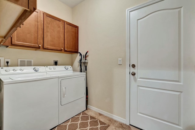 washroom with light tile patterned flooring, cabinets, and independent washer and dryer