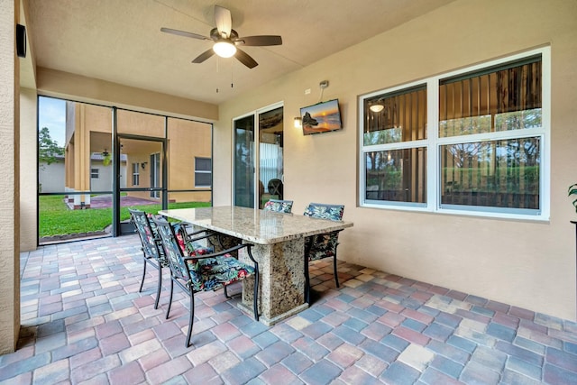 sunroom with ceiling fan