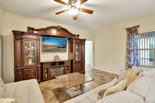 tiled living room featuring ceiling fan