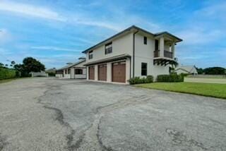 view of property exterior with a garage and a lawn