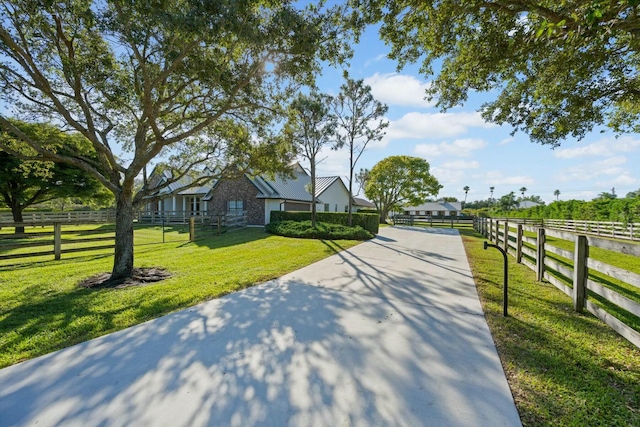 exterior space with a rural view and a front yard