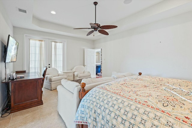 tiled bedroom with french doors, ceiling fan, and a tray ceiling