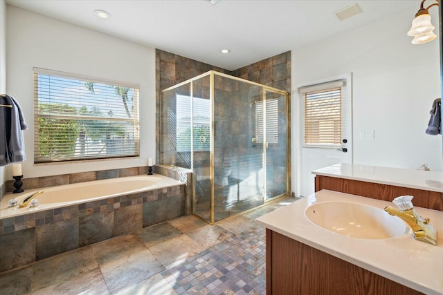 bathroom featuring independent shower and bath and vanity