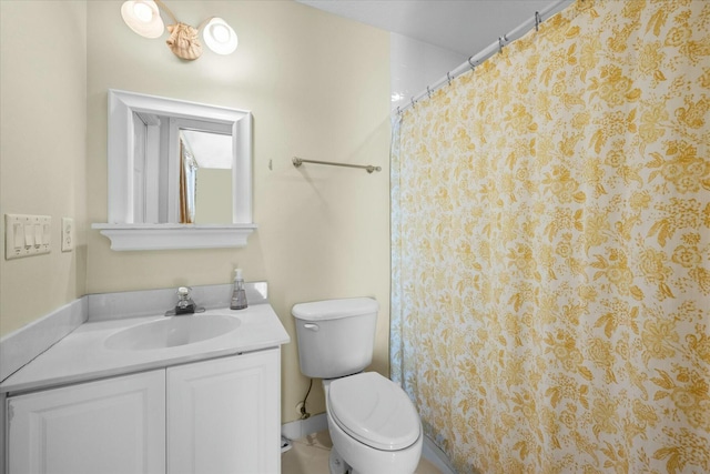 bathroom featuring vanity, toilet, and curtained shower