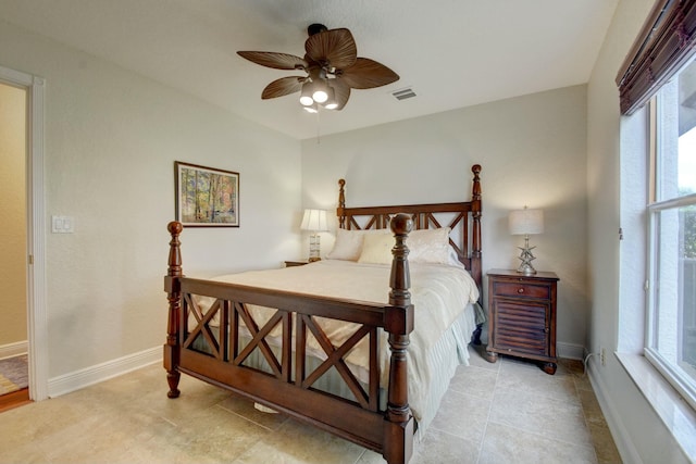 bedroom with multiple windows and ceiling fan