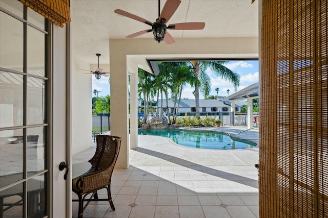 view of pool featuring ceiling fan and a patio area