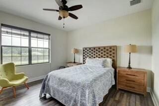 bedroom featuring ceiling fan and dark hardwood / wood-style flooring