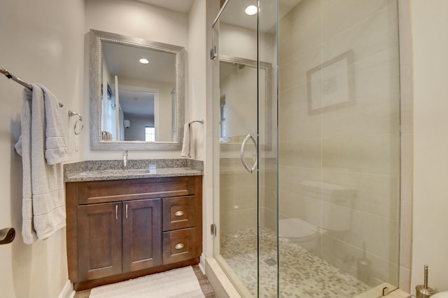 bathroom featuring an enclosed shower and vanity