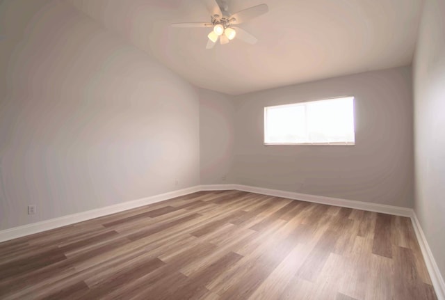 spare room with ceiling fan and wood-type flooring