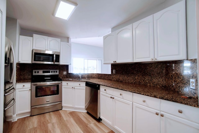 kitchen featuring white cabinetry and appliances with stainless steel finishes