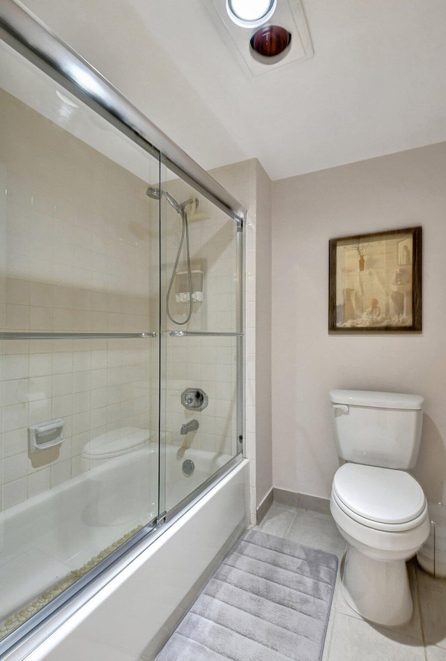 bathroom with enclosed tub / shower combo, toilet, and tile patterned flooring