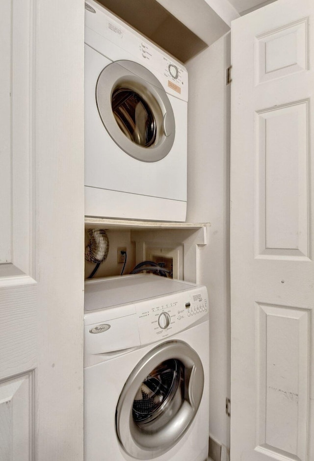 clothes washing area with stacked washer and dryer