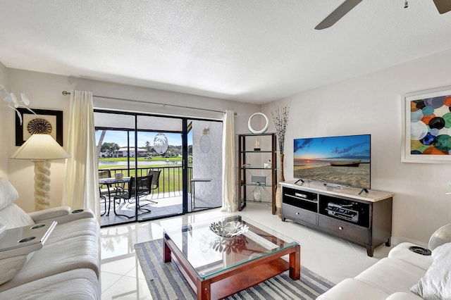 tiled living room featuring ceiling fan and a textured ceiling