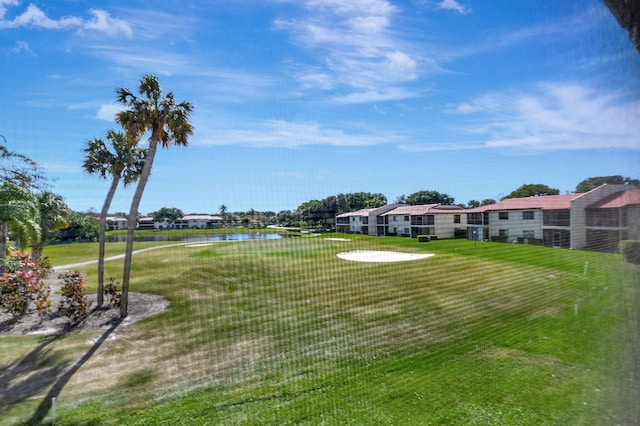 view of community with a water view and a lawn