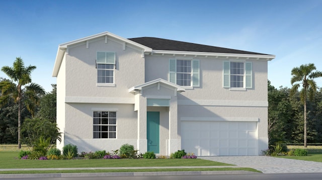 traditional-style house featuring a garage, a front lawn, decorative driveway, and stucco siding