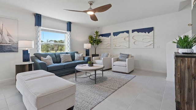 living area with ceiling fan, baseboards, and tile patterned floors